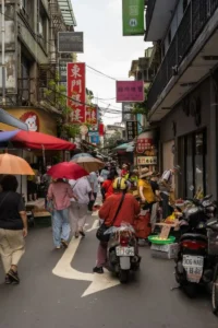 Busy street with small shops and people walking