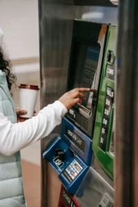 Person using a payment machine with coin and bill slots