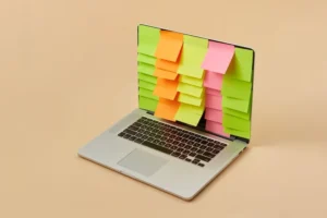 Laptop covered in blank coloured sticky notes