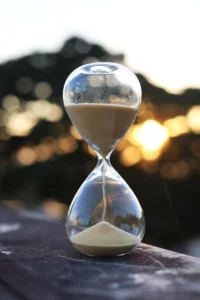 Glass hourglass with sand falling