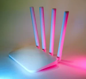 White home router with four antennas on a plain background