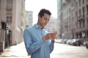 Man on a street looking at his phone