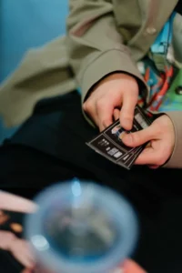 Person holding paper tickets in both hands