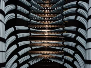 Rows of grey network cables running into a server rack