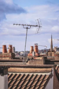 Television antenna on a rooftop above houses