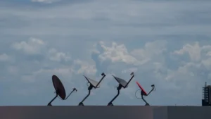 Satellite dishes on a roof against the sky