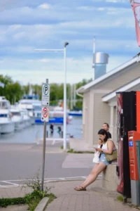 Woman outdoors using a smartphone while sitting outside